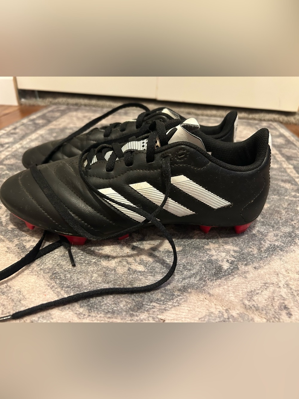 adidas Kids Black Soccer Cleats with White Stripes and Red Studs